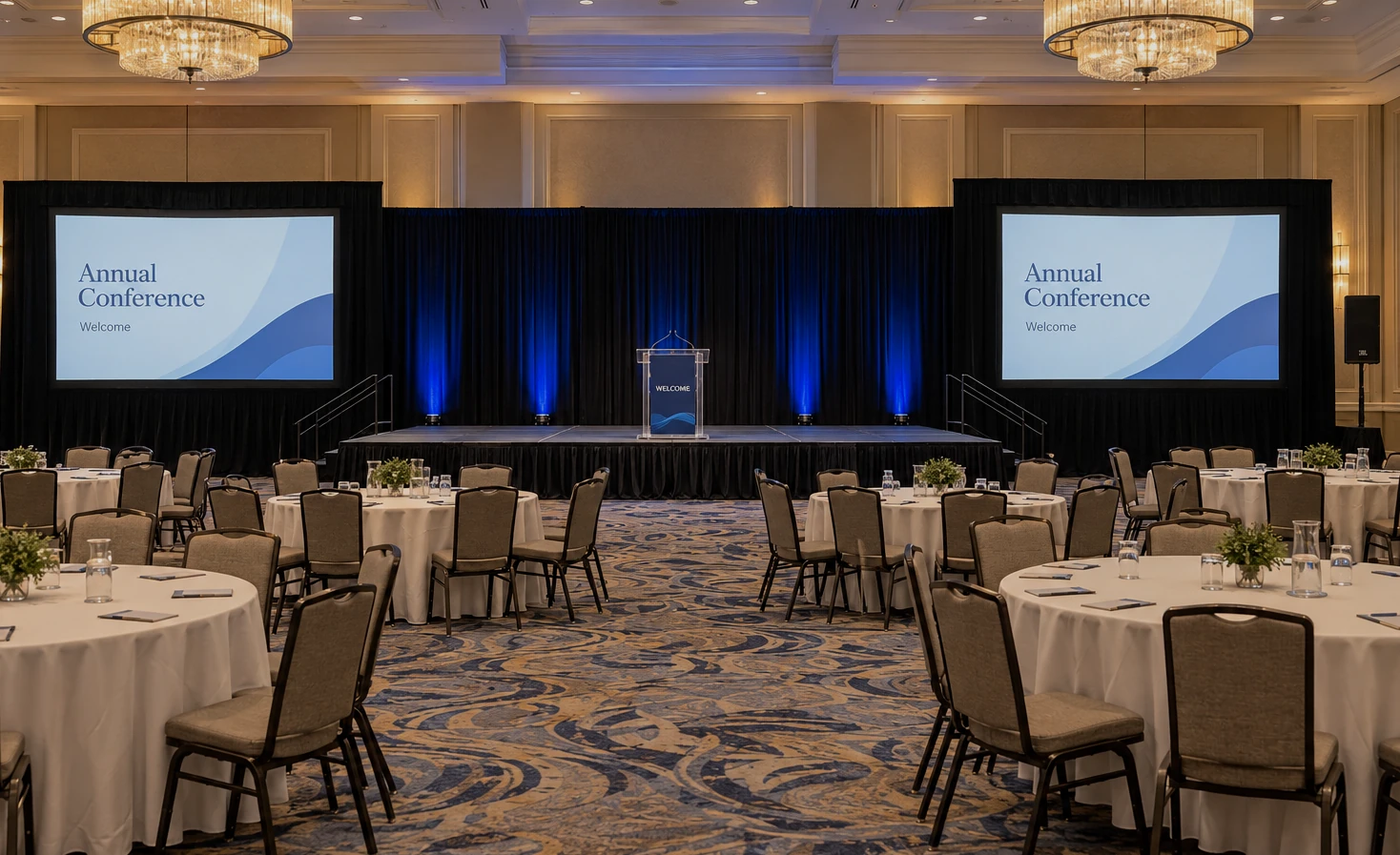 Illustrative ballroom setup with dual projection, blue lighting and a central stage